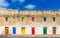 Marsaxlokk, Malta - Traditional maltese vintage house with orange, blue, yellow, red, green and brown doors and windows