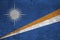 Marshall Islands flag depicted in paint colors on old brick wall. Textured banner on big brick wall masonry background