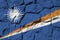 Marshall Islands flag depicted in paint colors on old stone wall closeup. Textured banner on rock wall background