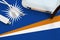 Marshall Islands flag depicted on table with internet rj45 cable, wireless usb wifi adapter and router. Internet connection