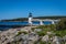 Marshall Point Lighthouse against a bright blue sky