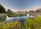 Marshland river system under foggy morning sunrise