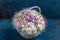 marshmallow bouquet of flowers in a basket on a blue background