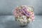 marshmallow bouquet of flowers in a basket on a light background