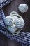 Marshmallow cakes lying in a bowl, next to a checked towel, on a dark wooden background.