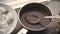 Marshmallow in a ceramic bowl and cocoa in a saute pan on a wooden stand