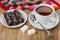 Marshmallow in chocolate in plate, cup of tea, sugar, teaspoon