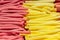 Marshmallow stick red pink yellow, close-up background wallpaper. Sweet candy marmalade in a supermarket. A large pile of fruit