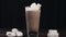 Marshmallows are added to the glass with hot cocoa drink, isolated glass of hot chocolate, milk and chocolate, hot sweet