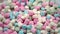 Marshmallows pink and white in the form of hearts rotate. Video close-up top view.