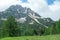 Marstein - A backpacker woman standing under a wooden cross on the top of Marstein, Austrian Alps.