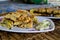 MARTABAK TELUR - stuffed pancake or pan-fried bread Indo-style on a plate, close-up with TERANG BULAN