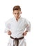 Martial art sport karate - child teen boy in white kimono training punch
