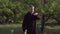 A martial artist practices tai chi taijiquan qigong in nature in a park