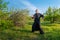 a martial arts master practiing qigong in a wild garden