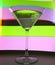 A martini glass with a cocktail in beautiful light of different colors