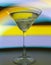 A martini glass with a cocktail in beautiful light of different colors