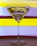 A martini glass with a cocktail in beautiful light of different colors