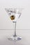 Martini glass and an olive drop