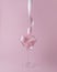 Martini glass with pink party ribbon. Minimal celebration concept