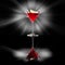 Martini glass with a slice of lemon on black reflective surface with glowing background