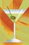 A martini with a green olive is seen in a martini glass on an abstract earth colored background