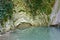 Marvellous lake with stagnant water among rocks covered with ivy and moss