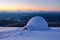 Marvelous huge white snowy hut, igloo the house of tourist is standing on high mountain far away from the human eye.