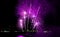 Marvelous purple pink fireworks exploding into the night sky over the city