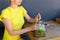 Marvelous young girl smiling, holds glass in hand, pours lemonad