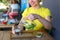 Marvelous young girl smiling, holds glass in hand, pours lemonad