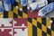 Maryland US state flag and few used aerosol spray cans for graffiti painting. Street art culture concept