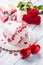 Marzipan white cake in the shape of a heart with red hearts. As the decoration bouquet of red roses a gift from the ribbon.