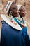 Masai or Maasai tribe woman in blue cloth wearing headpiece and ornaments. Ethnic group of Ngorongoro Consevation, Serengeti in