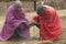 Masai male making fire by rubbing sticks together in village near Tsavo National Park, Kenya, Africa