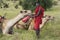 Masai in red robe and Camels and Acacia tree at Lewa Conservancy, Kenya, Africa