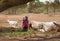 Masai shepheres with herd of goats near water hole