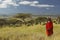 Masai Warrior in red surveying landscape of Lewa Conservancy, Kenya Africa