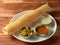 Masala dosa, a south Indian traditional and popular crepe with filling of a mixture of mashed potatoes and fried onions served