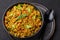 Masala Egg Bhurji or Muttai Podimas in black bowl on slate table top. Anda Bhurji is indian cuisine scrambled eggs dish