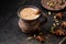 Masala pulled tea chai latte hot Indian sweet milk spiced drink, ginger, fresh spices and herbs blend