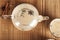 Masala tea on a textural wooden background. A teapot is a transparent tea pot with mugs and Indian national tea masala. Milk, ging