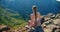 Masca Gorge and village on Tenerife Island. Young woman sitting on viewpoint with tropical nature landscape. Teno rural