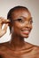 Mascara, happy woman and makeup in studio for beauty, cosmetics and smile on brown background. African model, makeover