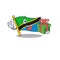 Mascot cartoon of happy flag tanzania with gift box