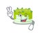Mascot of funny kiwi cake cartoon Character with two fingers