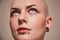 Masculine bald woman with piercing at her face