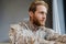 Masculine confident military man in uniform looking aside