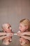 Masculine woman and feminine man looking at the each other while sitting at the table