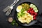 Mashed potato with green peas, tomatoes and boiled egg. Potato puree on plate with vegetables and egg